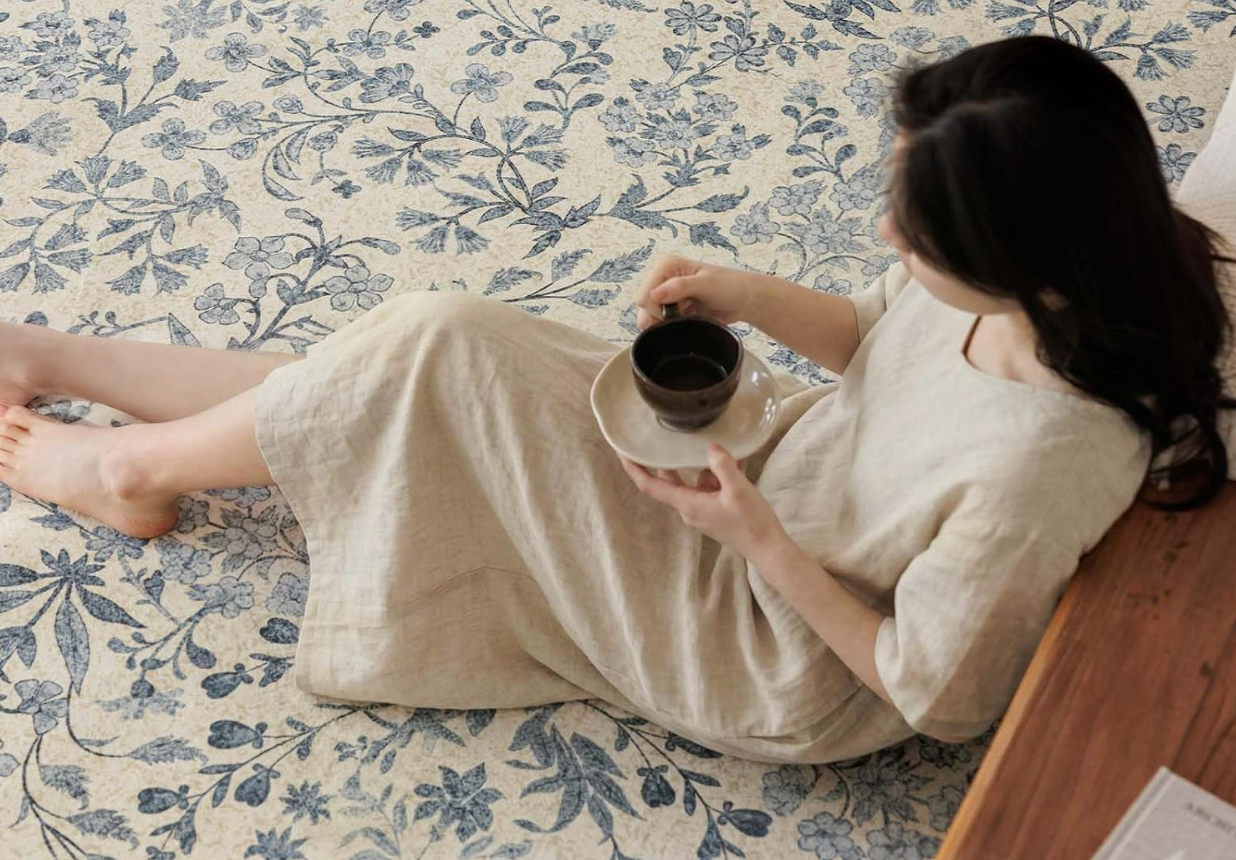 Woman sitting on a soft OEKO-TEX certified washable rug