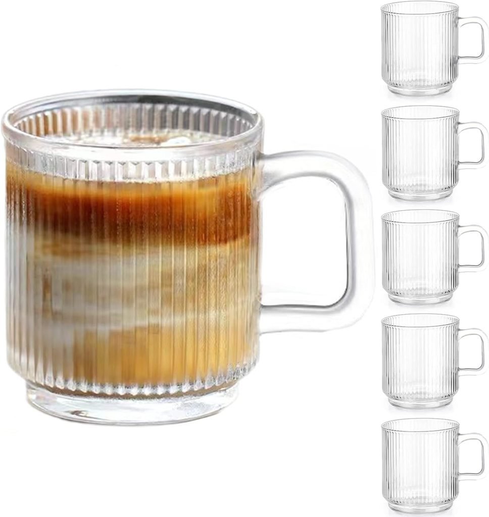 Clear vertical stripe glass coffee cup with handle on a light surface